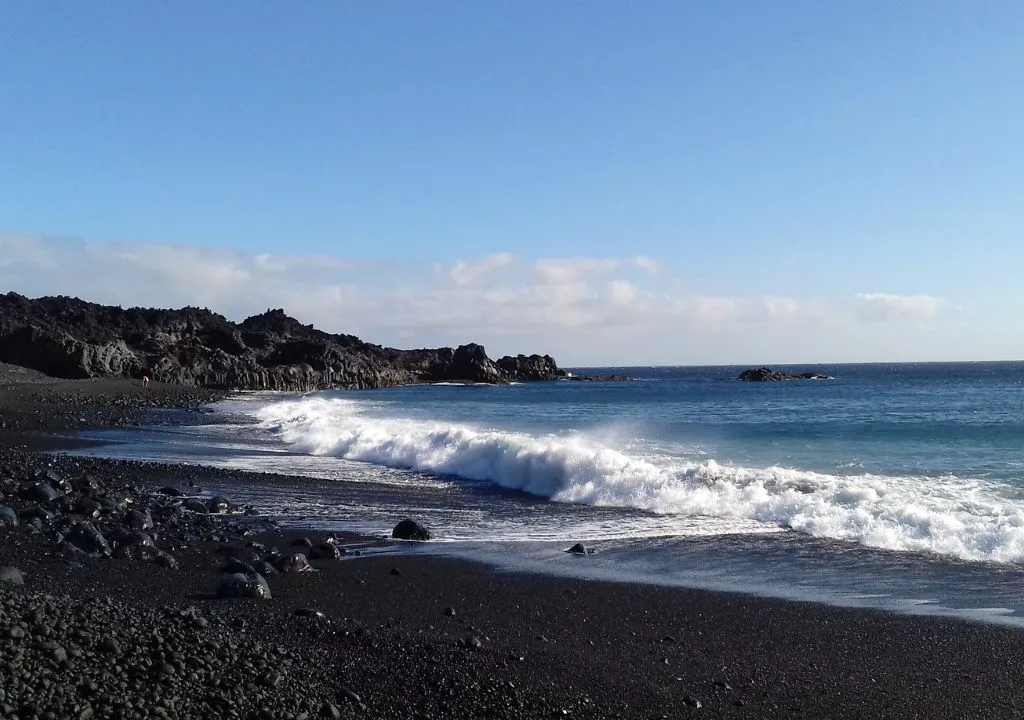 waves in the black sand